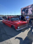 16 Bright red 1966 Chevrolet C10 with custom wheels drawing a crowd at the Triple Crown Truck Show