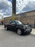 18 Modern Chevrolet Silverado SS with a retro inspired grille and wheels on display near the media center