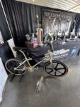 19 Gold themed BMX bike as part of the Triple Crown Truck Show exhibit surrounded by awards and trophies