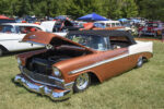 20 1957 Chevrolet Bel Air in bright red and white performing a smoky burnout on the strip at Beech Bend Raceway