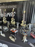 20 Display of unique Triple Crown of Rodding awards including custom guitars and automotive themed trophies