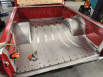 21 Progress on Chevy OBS bed showing metal tub shaping and floor reinforcement welds