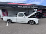 23 Clean white 1967 Chevrolet C10 with lowered stance and billet wheels on display at the Classic Car Studio booth