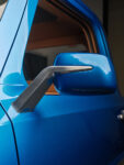 24 Close up of custom side mirror on 1969 Ford F 100 featuring a brushed metal arm and glossy blue housing