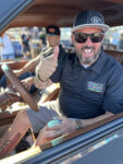 26 Enthusiast giving a thumbs up inside a modified truck radiating excitement and enjoying the event atmosphere