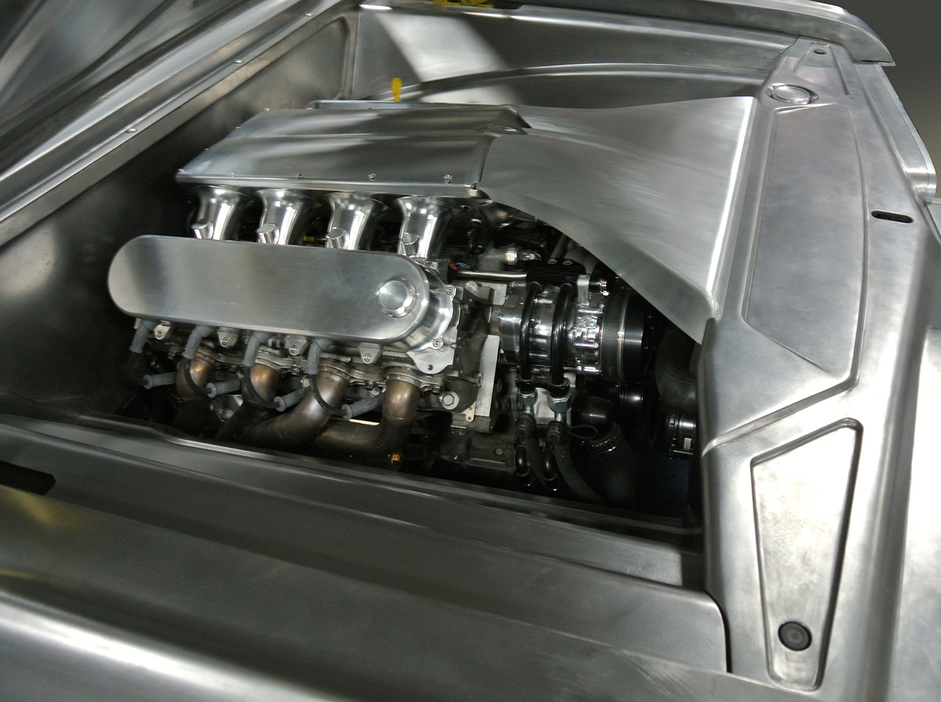 26 Fully fabricated engine bay with aluminum shielding and high performance headers in the 1959 Chevy