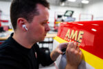 26 Precision hand painting AME Offroad graphics on the GMC K2500 for authentic detailing