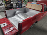 28 Fully restored Chevy OBS truck bed showcasing reinforced metal and custom fabricated wheel wells