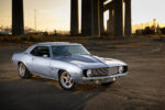 002 1969 Chevrolet Camaro showcases an aggressive hood scoop and custom grille emphasizing its pro touring style