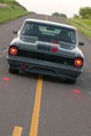 004 1967 Chevrolet Nova side profile highlights a lowered stance large chrome wheels and sleek custom bodylines