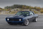004 1969 Camaro rear view showcasing a carbon fiber spoiler classic rectangular taillights and dual exhaust setup