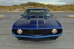 006 1969 Camaro engine bay featuring a Chevrolet LS V8 with Holley EFI carbon fiber details and polished valve covers