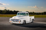 01 1956 Ford F 100 chrome grille white paint lowered stance and custom headlights on open road