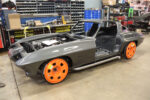 01 C2 Corvette undergoing a custom build with bright orange wheels smooth gray body and side exit exhausts