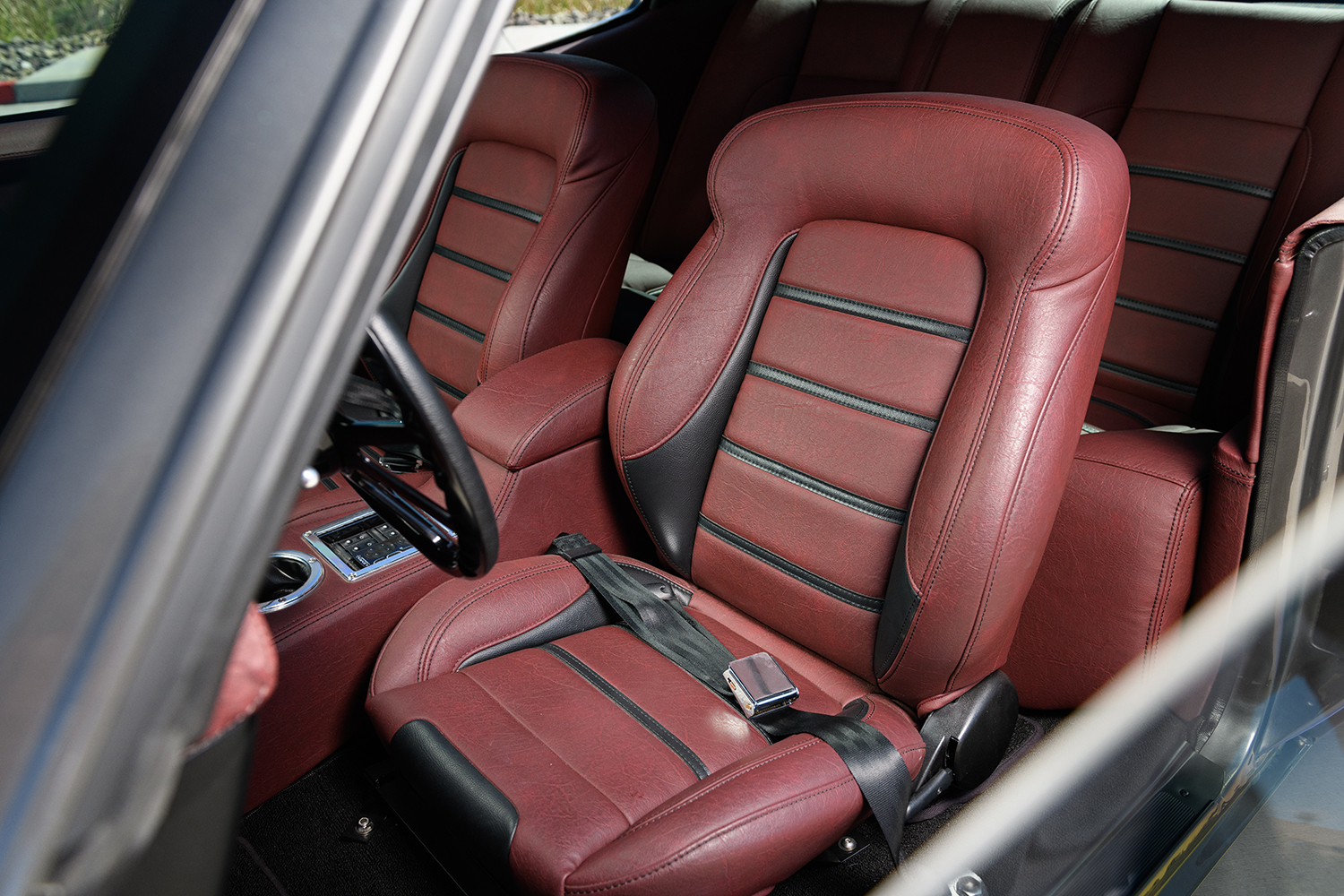 013 1970 Chevy Chevelle front seats in red leather with black accents showcasing luxury restoration