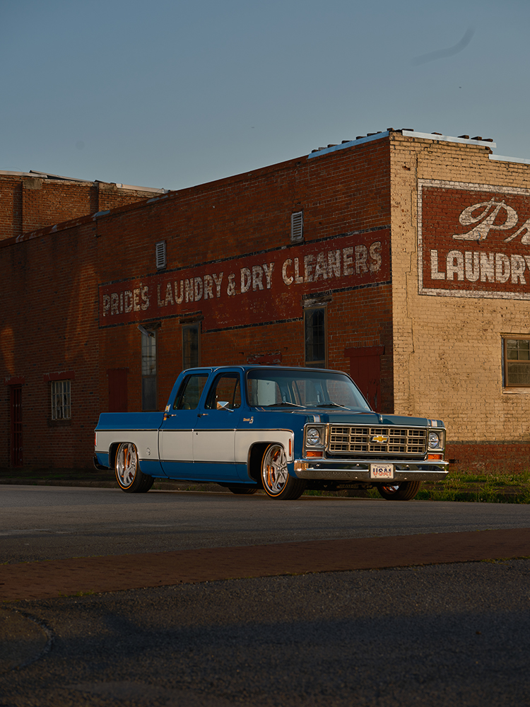 02 1979 Chevy Crew Cab blue and white two tone lowered with chrome grille vintage brick building background