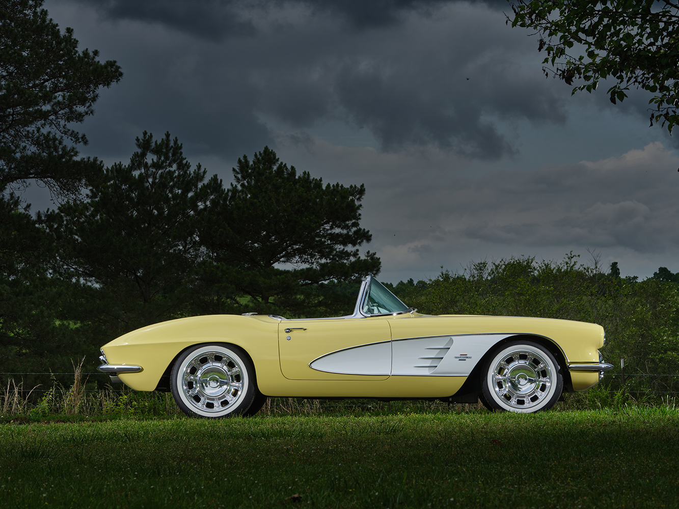02 Yellow 1961 Corvette restored white side coves chrome trim front three quarter view