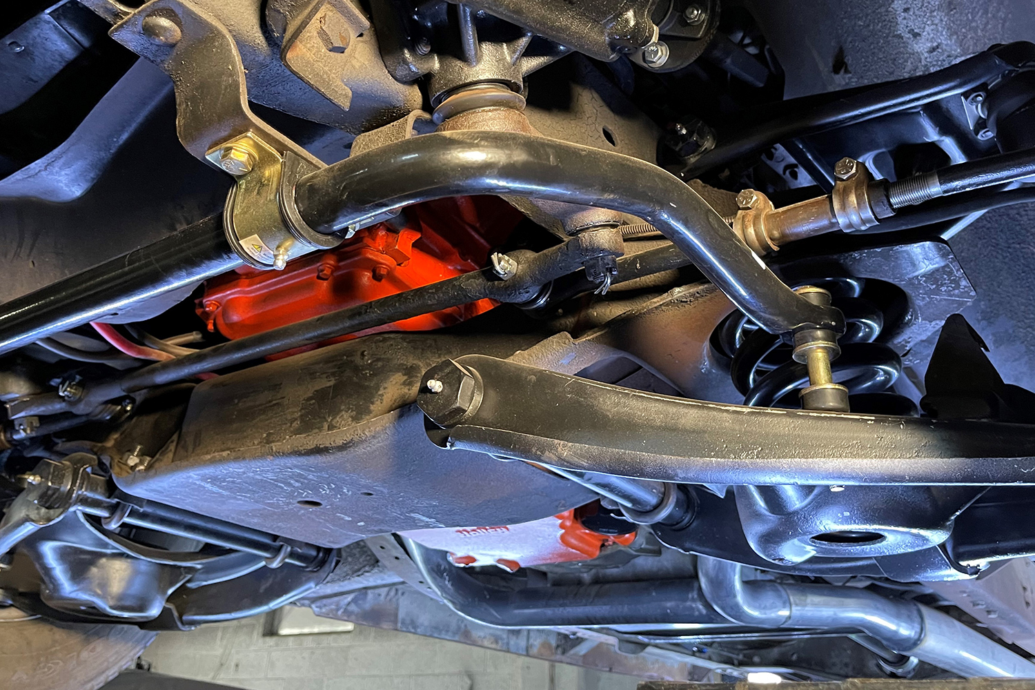 04 Installed IFS system under Chevy C10 with detailed view of sway bar control arms and crossmember integration