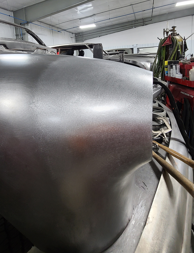 04 Smooth metalwork on the front fender of a 1951 Mercury during headlight housing fabrication process