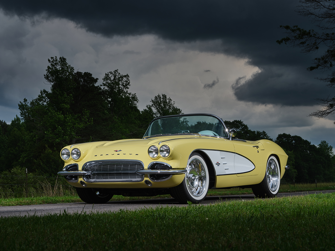 05 1961 Corvette convertible yellow parked country road lush greenery background