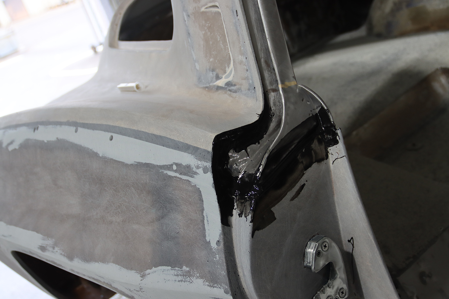05 Freshly applied fiberglass patch and smoothing work on the rear corner panel of a C2 Corvette