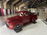 08 Deep red classic Ford F 1 truck with polished wheels and lowered stance in display area