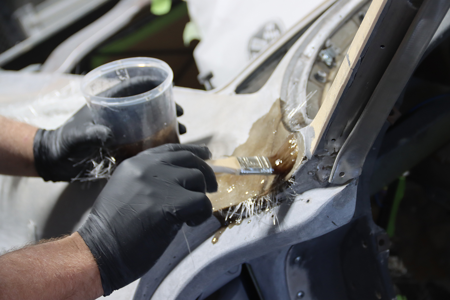 08 Hand applied fiberglass resin and cloth reinforcement on C2 Corvette s rear body seam