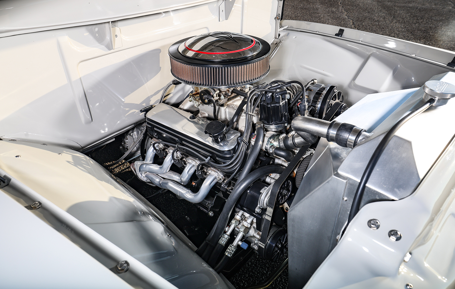 09 1956 Ford F 100 engine bay detail with aluminum radiator braided hoses and performance components