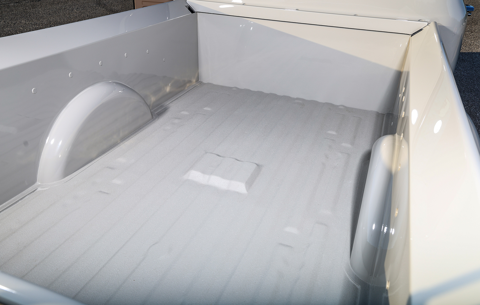 10 1956 Ford F 100 truck bed restoration showing smooth white paint rolled edges and inset wheel wells