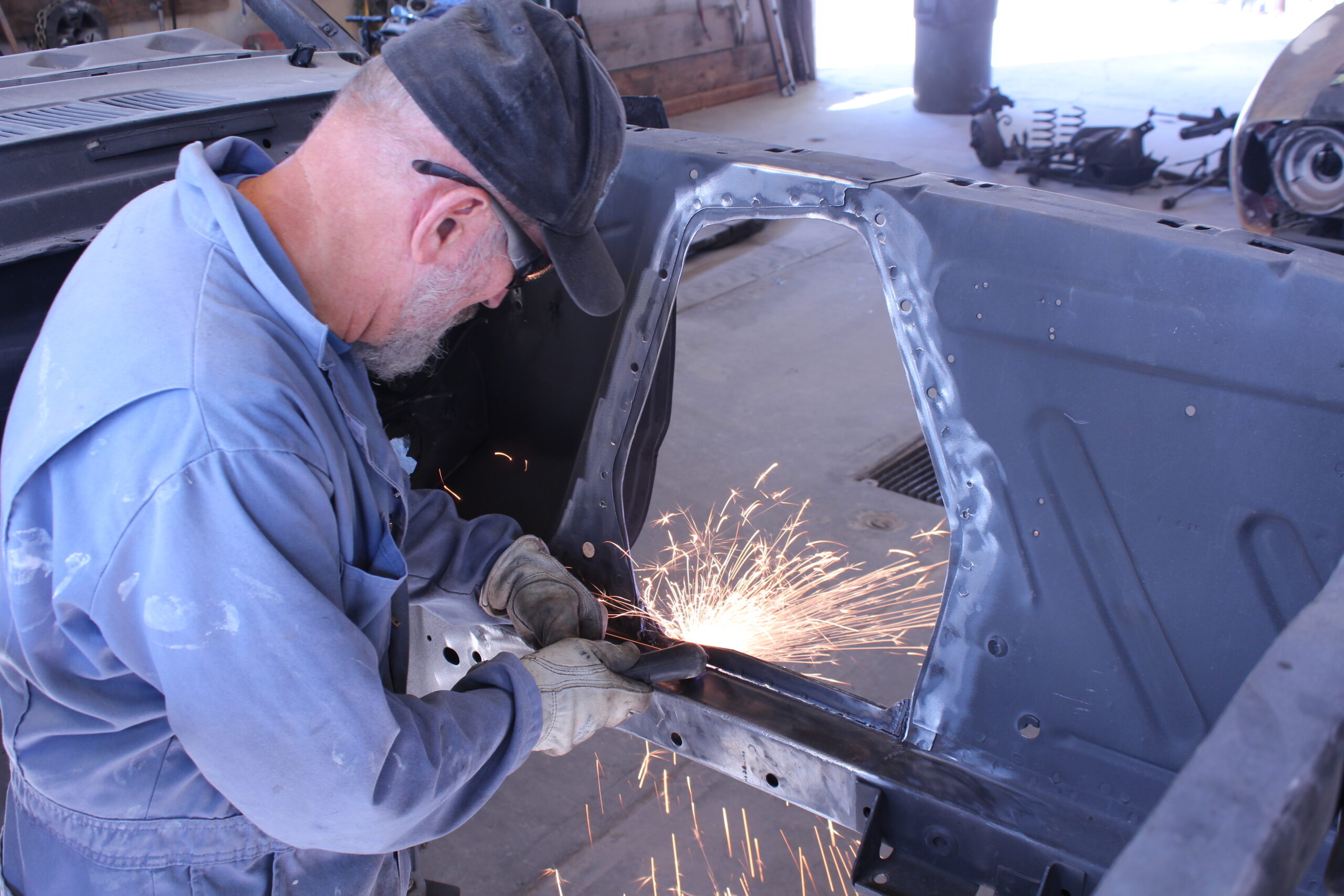 10 Metal fabrication in progress with sparks flying on a 1965 Ford Mustang Fastback frame rail