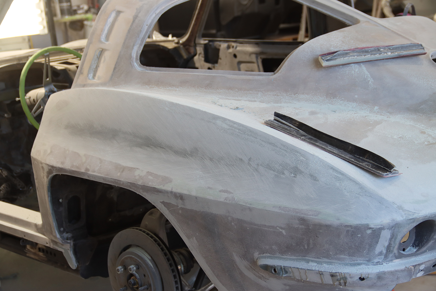 12 Bodywork smoothing and shaping the C2 Corvette rear panel to ensure a clean finish