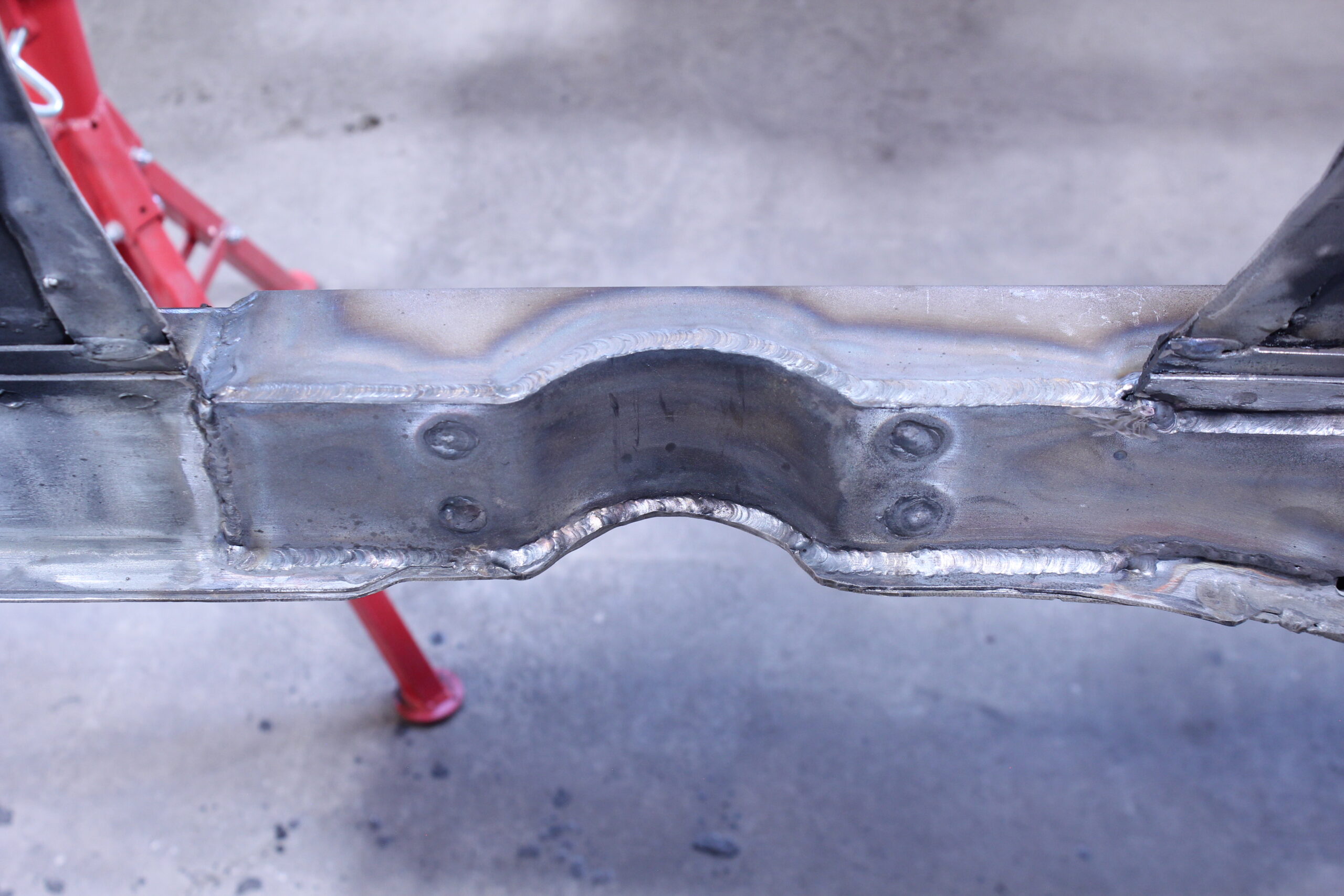 16 Fully welded frame rail reinforcement with smooth clean welds on a 1965 Mustang chassis