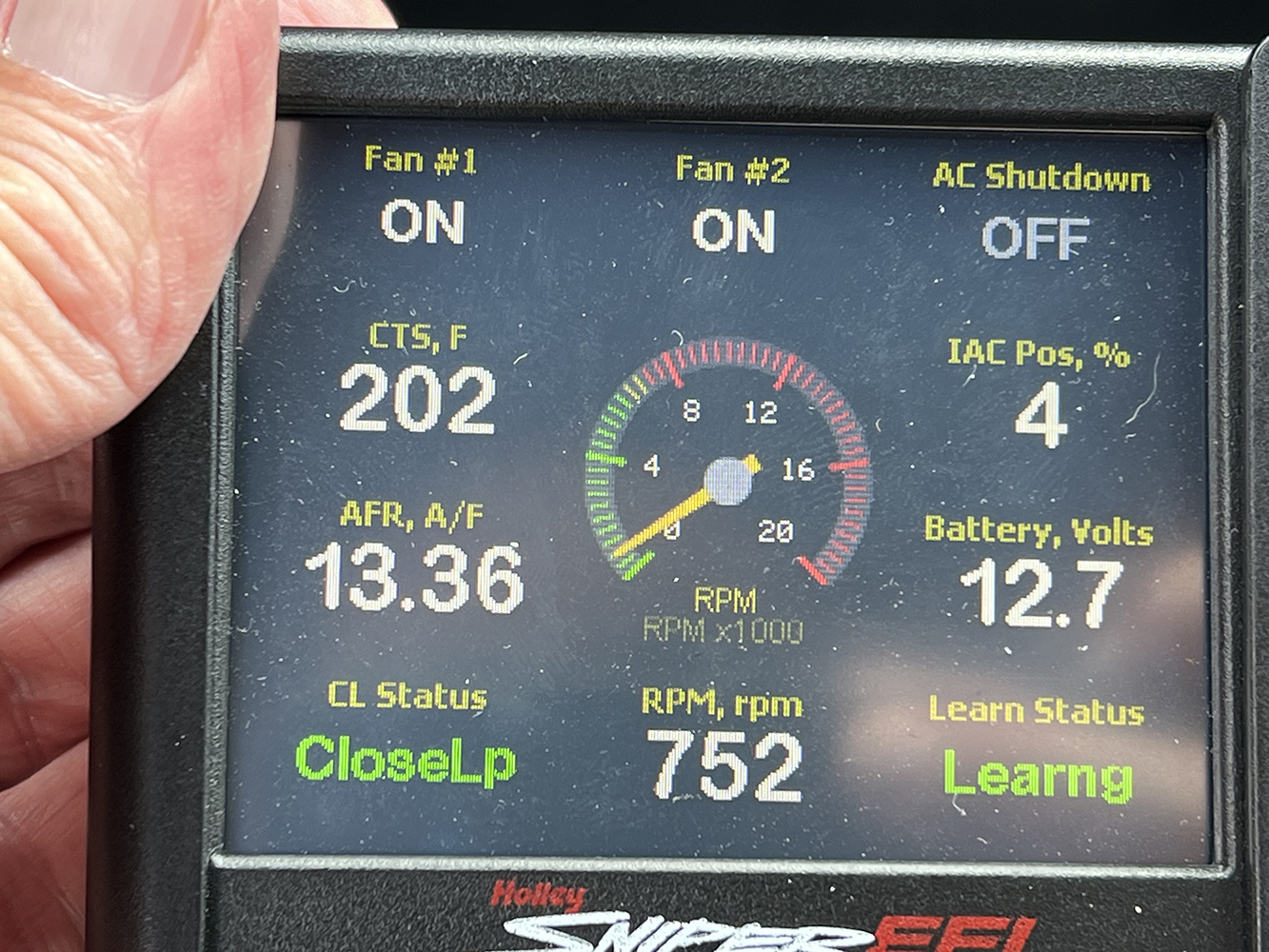 16 Holley Sniper EFI controller showing real time fan activation AFR and battery voltage