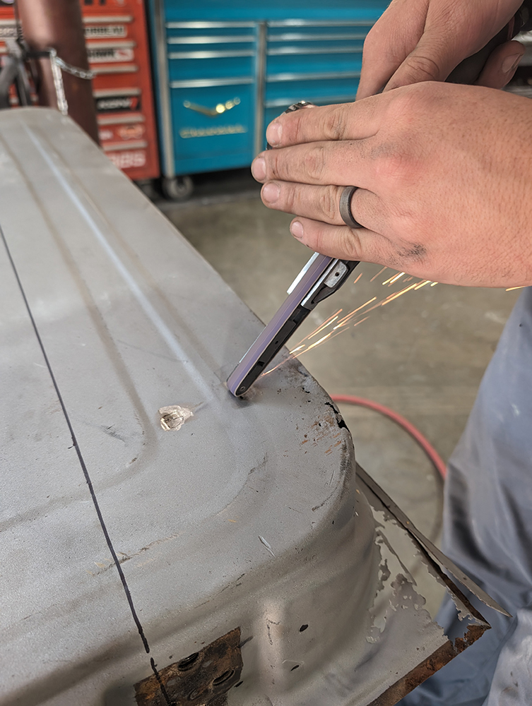 17 Filing edges with sparks flying during 1966 Chevy truck door panel refinishing