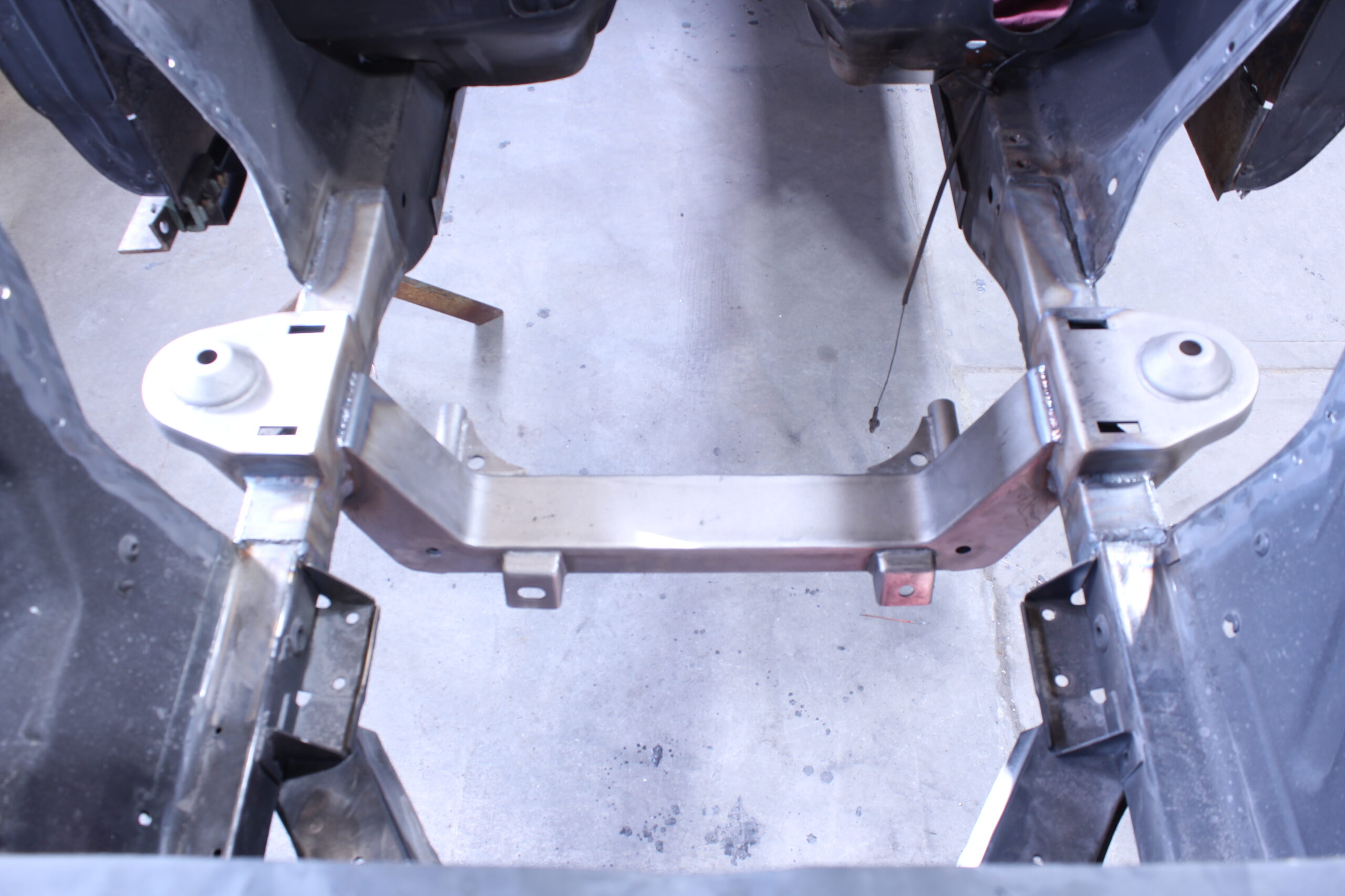 19 Fully installed crossmember and spring perches welded in for a 1965 Ford Mustang chassis upgrade