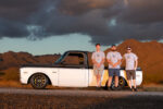 20 Three team members posed beside a 1969 Chevrolet C10 showcasing the truck’s profile and customization