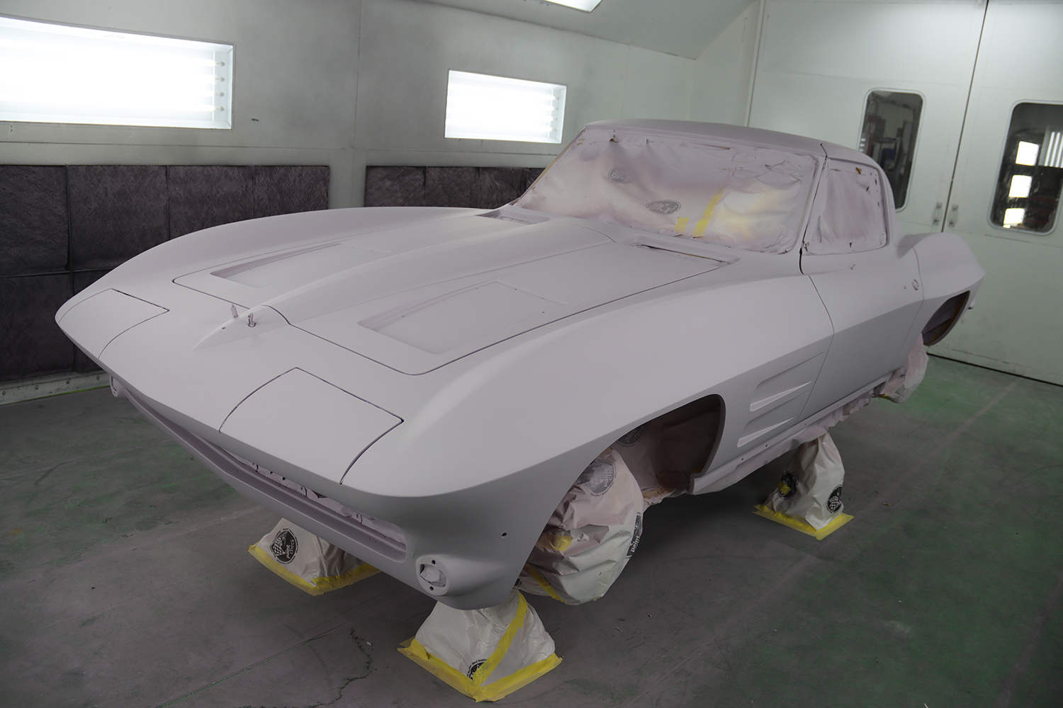 23 Fully primed C2 Corvette body showcasing smooth flawless fiberglass prep before the final paint stage