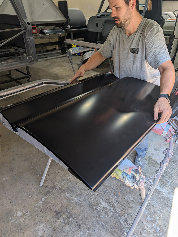 28 Inspecting black outer skin fitted to 1966 Chevy truck door during restoration