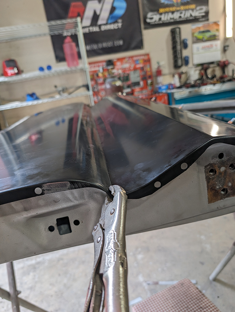 39 Vice grip holding curved edge of 1966 Chevy truck door replacement panel for final adjustments