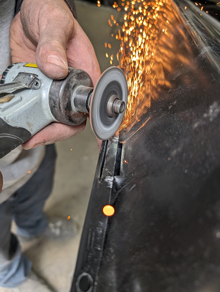 41 Grinding welds smooth on 1966 Chevy truck door panel with sparks flying
