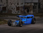 01 1928 Ford channeled sedan rat rod angled side view graffiti wall
