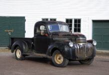 01 1946 Chevy Truck black patina pre restoration parked by a garage