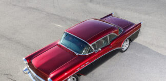 01 1957 Buick two tone body with deep red and black paint chrome trim and a sleek vintage profile