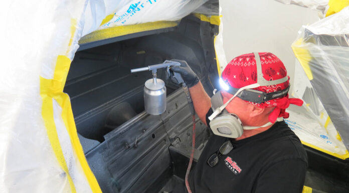 01 Technician applying advanced thermal acoustic coating inside a 1972 Corvette for enhanced heat and sound insulation