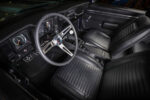 011 1969 Chevy Camaro interior with classic black upholstery and vintage steering wheel design