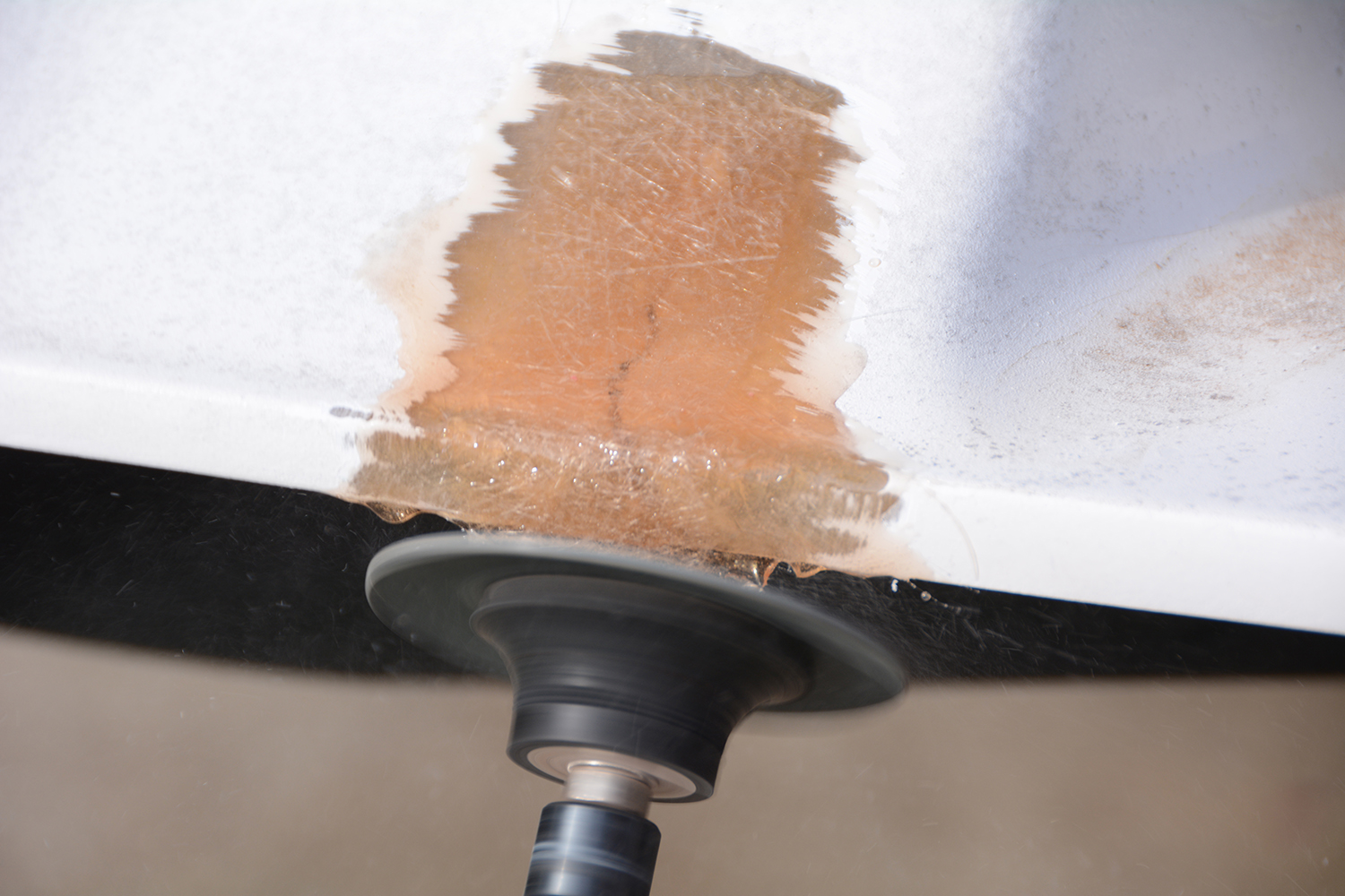 014 A power tool smooths the cured fiberglass area blending it into the surrounding surface