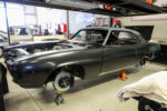 017 1969 Chevy Camaro matte black body during restoration on jack stands