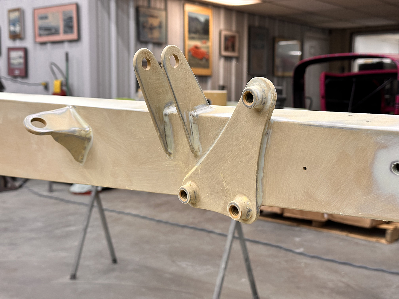 02 Close up of bracket reinforcements on a meticulously sanded and primed custom roadster frame