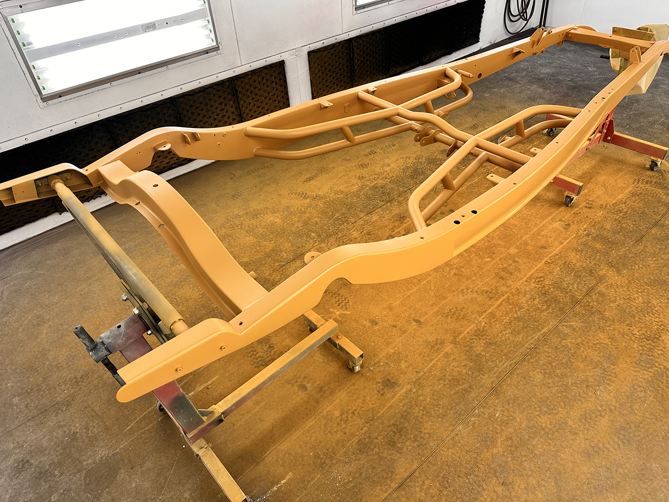04 Freshly painted roadster frame in vibrant yellow primer prepped for additional coats