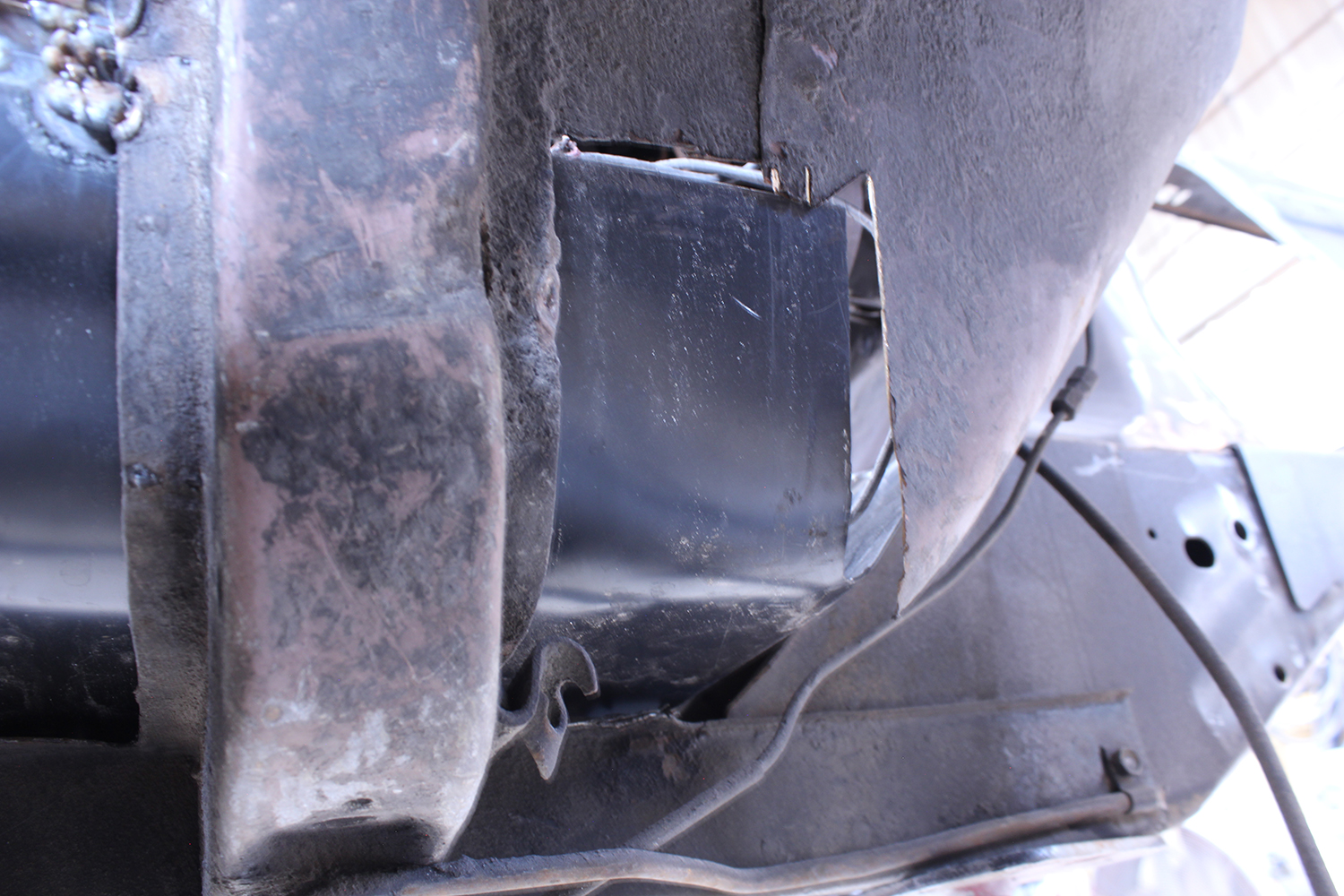 05 Partially installed patch panel on 1965 Ford Mustang visible welds and restoration in progress